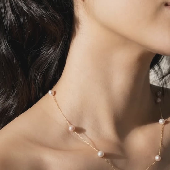 Lavender pearl stud worn on ear, showing its 8–9mm size_video